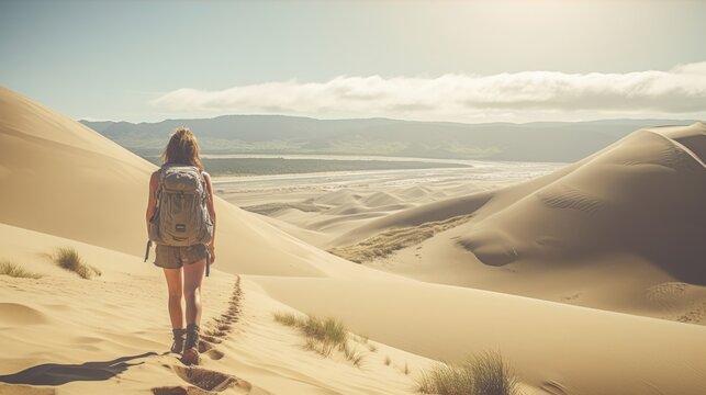 Photo of a woman walking in the desert with a backpack. Wanderlust