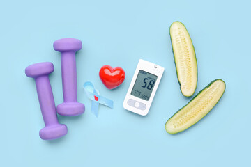 Glucometer with heart, cucumber, dumbbells and awareness ribbon on blue background. Diabetes concept