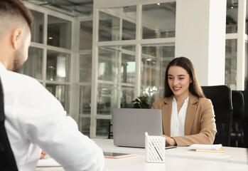 Colleagues working together in open plan office