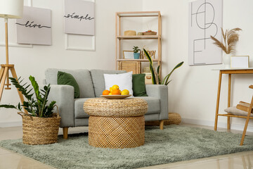 Interior of stylish living room with wicker table and sofa