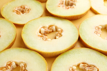 Slices of sweet melon on yellow background