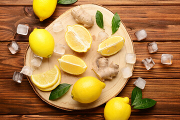 Board with ingredients for preparing lemonade on wooden background