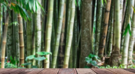  Rustic wooden empty deck and blurred bamboo forest background. © JCLobo