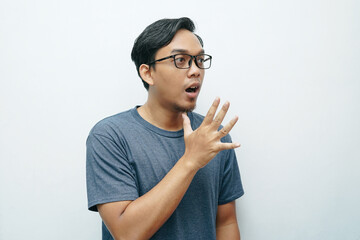 Portrait of Indonesian Asian man showing mother sign language for deafness gesture. Isolated white background