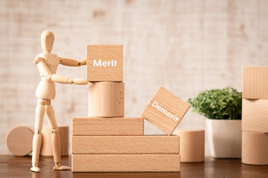 There is wood cube with the word Merit Demerit. It is as an eye-catching image.