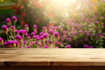 Empty wooden table with Gomphrena globosa background at sunrise for product presentation, space for montage showing products