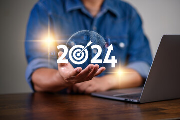 Business growing in 2024, Businessman showing word 2024 marketing monitor and business planing in new year concept. marketing financial and research analysis, business planning and strategy concept.