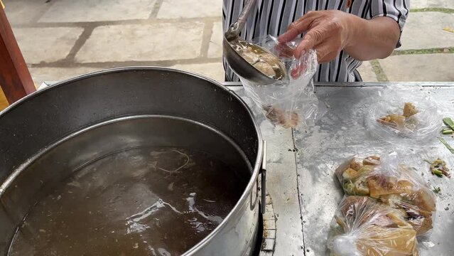 Street food booth selling Bakso which is Indonesian meatball with beef stock soup and many other condiments