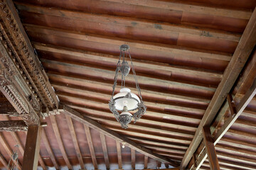 ancient Javanese hanging lamps on building roofs and carved ceilings typical of ancient Indonesian Javanese