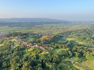 Fototapeta na wymiar View of forests, fields, villages and Zagorje hills, during a panoramic balloon flight over Croatian Zagorje - Croatia (Panoramski let balonom iznad Hrvatskog zagorja - Hrvatska)