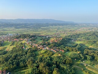 Obraz premium View of forests, fields, villages and Zagorje hills, during a panoramic balloon flight over Croatian Zagorje - Croatia (Panoramski let balonom iznad Hrvatskog zagorja - Hrvatska)