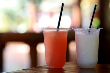 Healthy smoothies with fresh ingredients on a kitchen board.