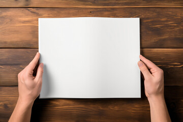 Close-up of hands holding white paper book