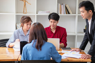 Asian business team consists of marketing staff. accountant and financial officer Help each other...