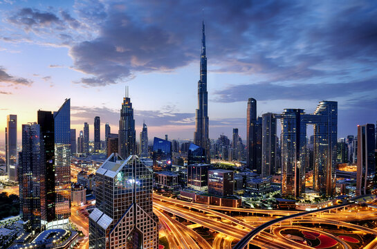 Fototapeta Dubai modern skyline  architecture by night with illuminated skyscrapers, United Arab Emirates