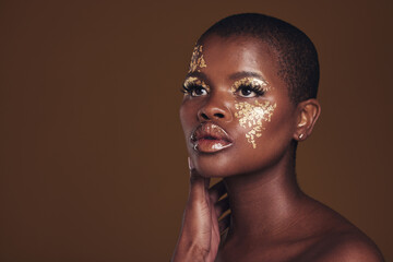 Art, mockup and black woman with gold makeup on brown background, glitter paint and cosmetics. Shine, glow and African model in studio for beauty, fashion and aesthetic freedom in luxury skincare.