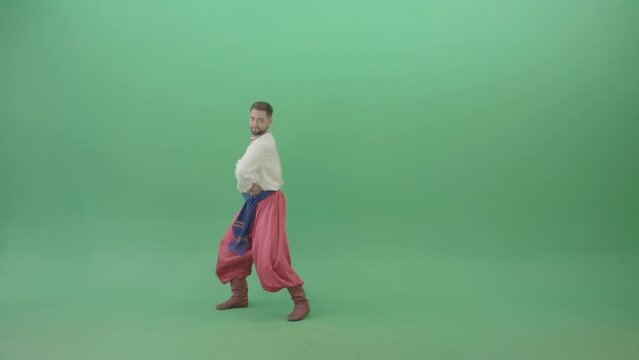 Slavic dancing man dance hopak in national ukraine costume isolated on green screen