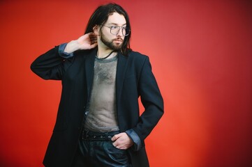 Gay man hold rainbow striped flag isolated on colored background studio portrait. People lifestyle fashion lgbtq concept