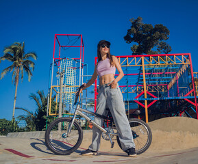 Happy young woman enjoy BMX riding at the skatepark