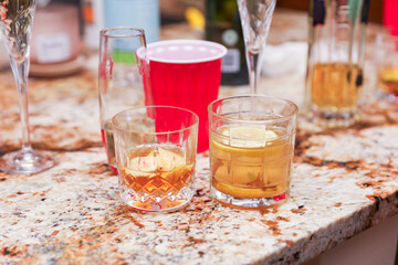 Plastic cups at a lively party embody celebratory spirit, casual socializing, and youthful...