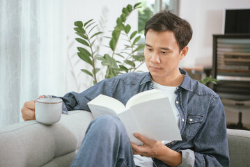 Asian guy are reading the book at home