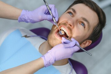 Man having teeth examined at dentists