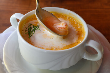 Busumer Krabbensuppe, Busom Style Soup with North Sea Crabs or Brown Shrimps on a Spoon in a White Bowl