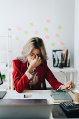 Portrait of business owner, woman using computer and financial statements Anxious expression on expanding the market to increase the ability to invest in business