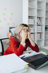 Portrait of business owner, woman using computer and financial statements Anxious expression on...