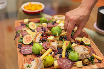 Hands and utensils gather around, embracing the communal spirit of a potluck dinner. Symbolizing unity, sharing, and indulgence as they enjoy a variety of desserts