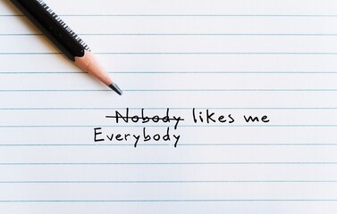 Pencil on paper with text written NOBODY LIKES ME changed to EVERYBODY LIKES ME  to replace...