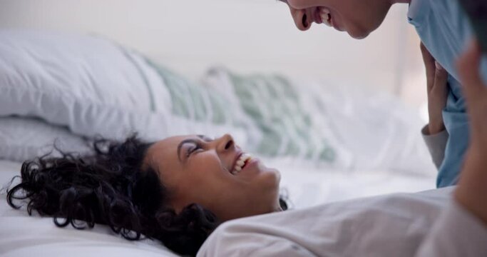 Love, bedroom and lesbian couple kiss, laugh and playful gay women, trans girlfriend or partner smile for fun morning. LGBTQ, happy and people bond, connect and enjoy time together in home apartment