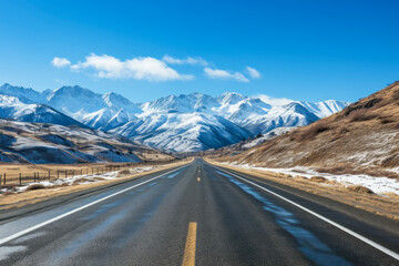 Straight very long asphalt road in a Beautiful winter mountain landscape with a blue sky in the background. good business concept for life and success.