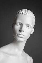 Portrait of luxury white female mannequin isolated on gray background.