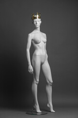 Fototapeta premium White female mannequin with golden crown on her head. Vip boutique concept. Shop queen.