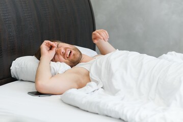 Young man in bed , trying to sleep