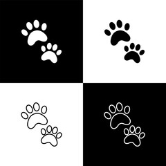 Fototapeta na wymiar Set Paw print icon isolated on black and white background. Dog or cat paw print. Animal track. Vector