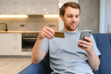 Online payment,Man holding a credit card and using smart phone for online shopping