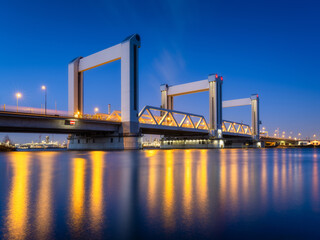 Botlek bridge, Rotterdam, Netherlands. View of the bridge at night.  Road for cars and railroad...