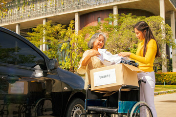 Elderly mother and her asian philanthropist daughter drive to the shelter to donate wheelchairs and...
