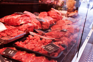 Pork, beef, tenderloin, meatballs, entrecote, ham, carbonate in refrigerator on market counter