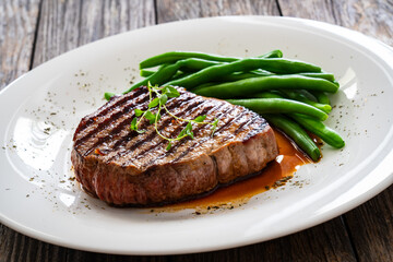 Grilled beef steak on wooden table

