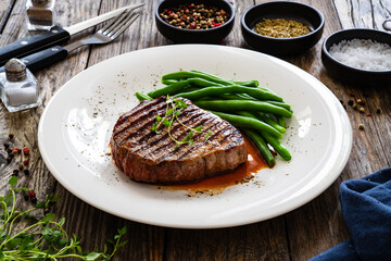 Grilled beef steak on wooden table

