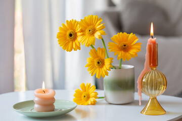 yellow gerbera in ceramic vase in light living room