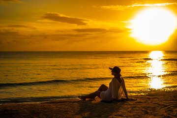 Woman on sunny, tropical beach at daybreak 
