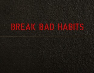 Black rough textured copy space wall with a line with text BREAK BAD HABITS , concept of to stop or give up some bad harmful habits that is difficult to kick out and try hard to make a change