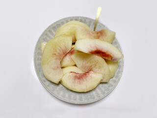 Sliced ​​white peach on white background