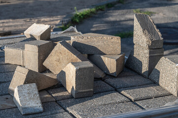 A pile of pieces of concrete paving stones for laying footpaths.