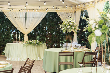 A beautiful vase of flowers on a table in a luxury restaurant. Wedding decorations