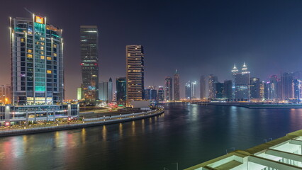 Fototapeta na wymiar Modern city architecture in Business bay district. Panoramic view of Dubai's skyscrapers day to night timelapse